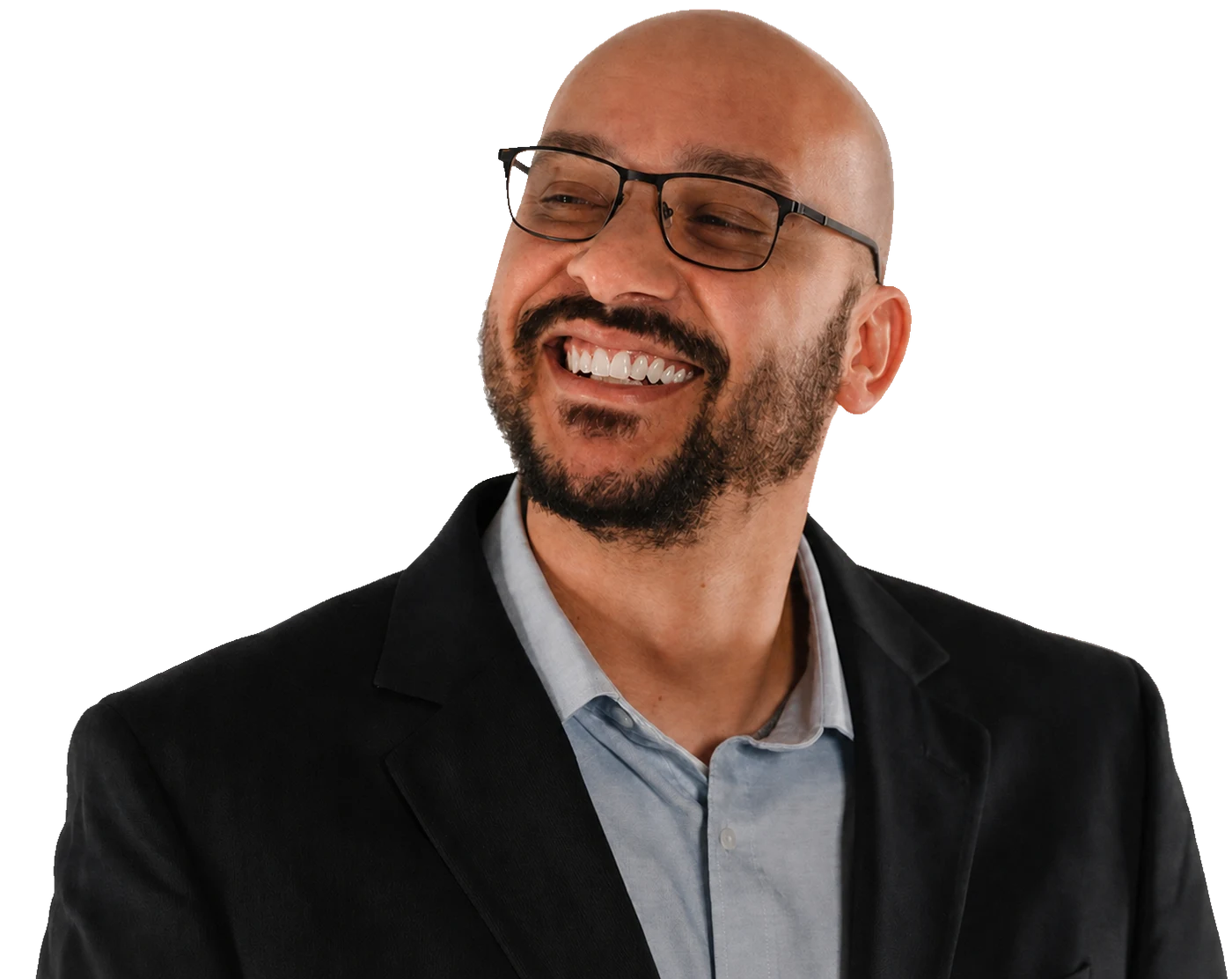 Miles Greer smiling, wearing glasses and a black blazer