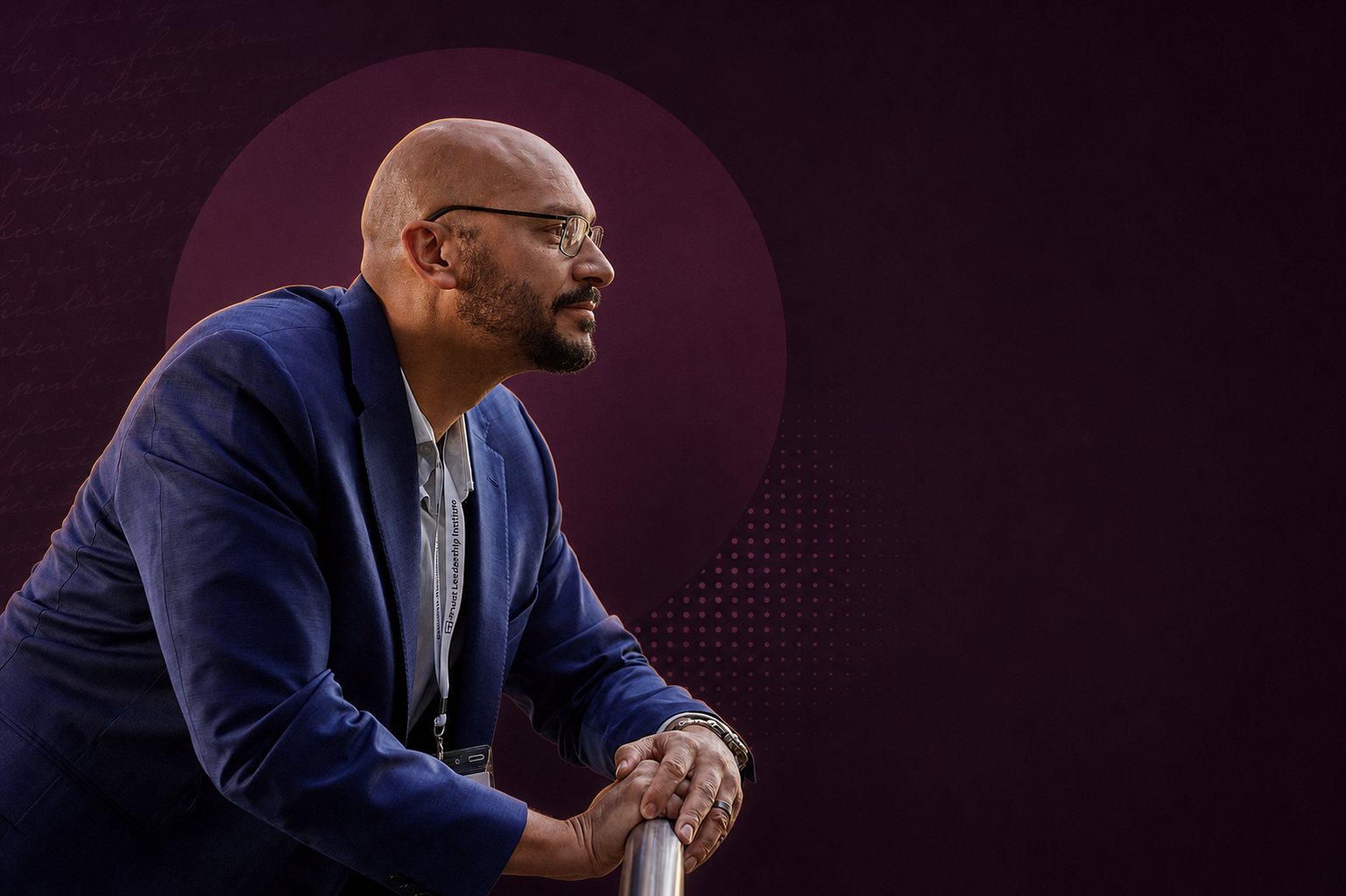 Miles Greer seated against an aubergine editorial backdrop